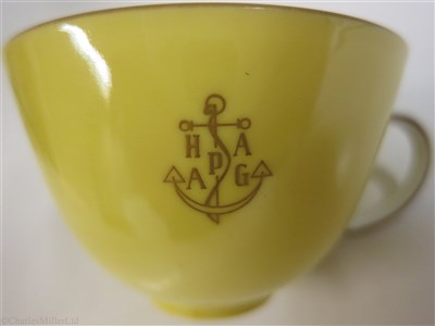Lot 56 - HAMBURG-AMERICAN (H.A.P.A.G.) LINE: A YELLOW PORCELAIN COFFEE CUP AND SAUCER BY FÜRSTENBERG, GERMANY, CIRCA 1950