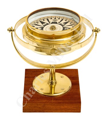 Lot 261 - A DECORATIVE BRASS AND WOOD DESK COMPASS