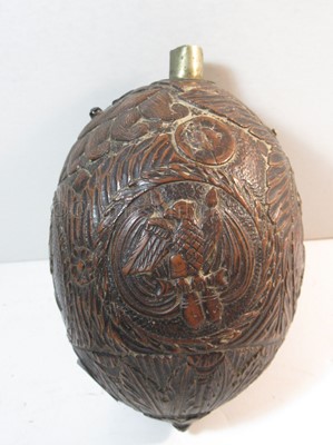 Lot 159 - AN EARLY 19TH CENTURY CARVED COCONUT BUGBEAR POWDER FLASK