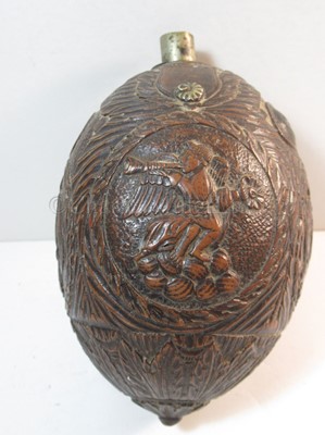 Lot 159 - AN EARLY 19TH CENTURY CARVED COCONUT BUGBEAR POWDER FLASK