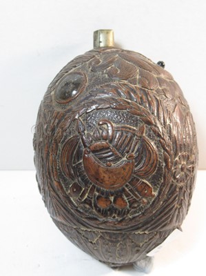 Lot 159 - AN EARLY 19TH CENTURY CARVED COCONUT BUGBEAR POWDER FLASK