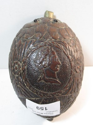Lot 159 - AN EARLY 19TH CENTURY CARVED COCONUT BUGBEAR POWDER FLASK