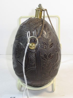 Lot 29 - A FINELY CARVED COCONUT BUGBEAR FLASK, FIRST QUARTER 19TH CENTURY