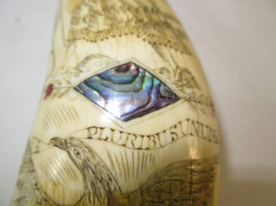 Lot 45 - Ø AN UNUSUAL SCRIMSHAW DECORATED WHALE'S TOOTH