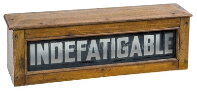 Lot 303 - AN ILLUMINATED NAME BOX FROM A LAUNCH OF H.M. AIRCRAFT CARRIER INDEFATIGABLE, 1942