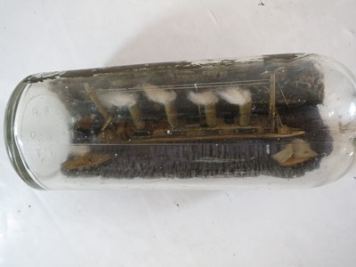 Lot 79 - A COMMEMORATIVE SHIP IN BOTTLE MODEL OF R.M.S. LUSITANIA MADE BY A SURVIVOR, 1915