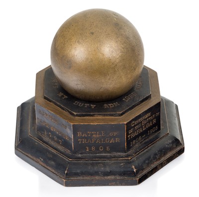 Lot 144 - A 1905 TRAFALGAR CENTENARY CANNON BALL AND STAND COMMEMORATING H.M.S. VICTORY'S BATTLES