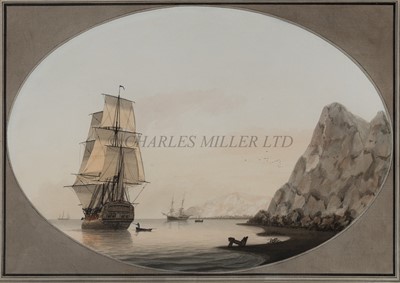 Lot 236 - SAMUEL ATKINS (BRITISH, CIRCA 1787-1808) - A sixth rate making sail out of a rocky cove, with an anchored merchant brig nearby