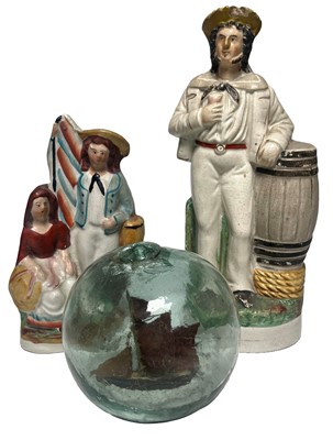 Lot 18 - TWO STAFFORDSHIRE FIGURES AND A SHIP IN A GLASS FLOAT