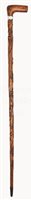 Lot 133 - A WALKING STICK CARVED FROM TIMBER RECOVERED...