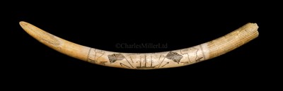 Lot 86 - A SCRIMSHAW-DECORATED WALRUSS TUSK<br/><br/>incised...